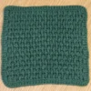 Solid Forest Green hand-crocheted cotton washcloth with rounded corners and tidy finished edges.