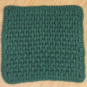 forest-green-crochet-washcloth-cotton Solid Forest Green hand-crocheted cotton washcloth with rounded corners and tidy finished edges.
