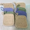 Two stacks of 4 handmade cotton face scrubbies by Patient Calf, showing the thick, textured crochet stitch and hanging loops in assorted earthy tones.