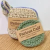 sand-colored square scrubby with a hanging loop and sage green round crochet face disc , both featuring Patient Calf branding and "Made in Canada" labels.