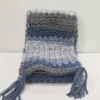 The Drina Scarf draped to show its full length and the varying shades of blue and grey stripes.