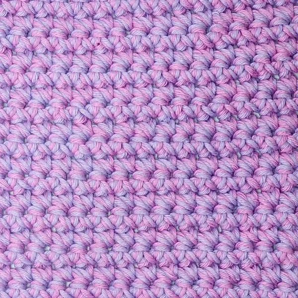 Close-up of the nubby, thick cotton crochet stitches on the Loire washcloth by Patient Calf.