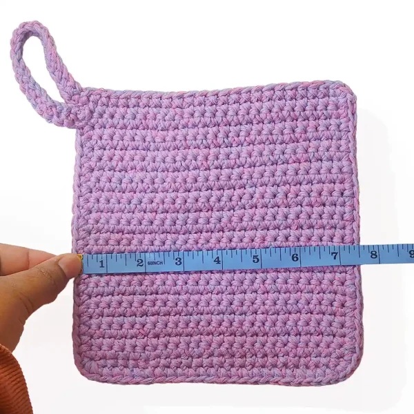 atient Calf Loire washcloth being measured with a blue tape measure, showing a width of 7.5 inches.