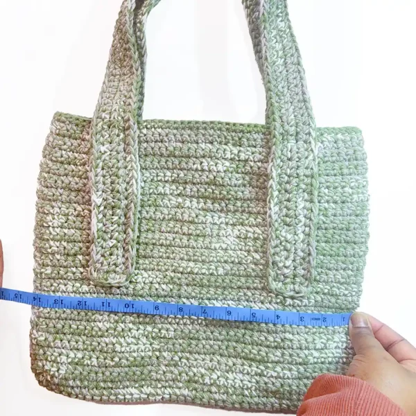 The Rowan Tote by Patient Calf in Sage Green and Parchment, showing a 14-inch width with a measuring tape.