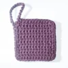 The Iris facial scrubbie by Patient Calf in Vintage Purple, showing the intricate, hand-crocheted nubby stitch.