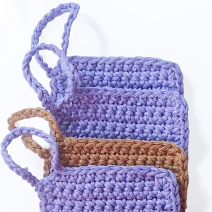 Three Iris scrubbies layered to show the neat square finish and sturdy hand-crocheted finger loops.