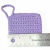 Close-up of a soft lilac Iris scrubbie by Patient Calf measured with a stainless steel ruler to show the 3 inch (7.6 cm) width.
