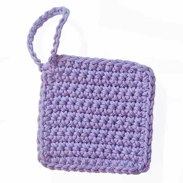 Close-up of the nubby, hand-crocheted texture of the Iris scrubbie in Soft Lilac by Patient Calf.