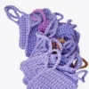 A textured stack of hand-crocheted Iris scrubbies in Soft Lilac and Fudge brown showing the finger loops.