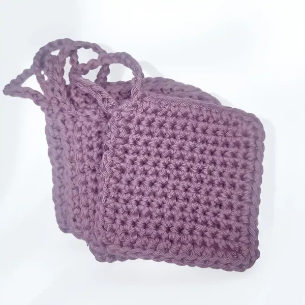 A soft, textured stack of hand-crocheted Iris scrubbies in the Vintage Purple shade by Patient Calf.