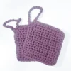 Two hand-crocheted Iris facial scrubbies in Vintage Purple showing the nubby exfoliation texture and loops.